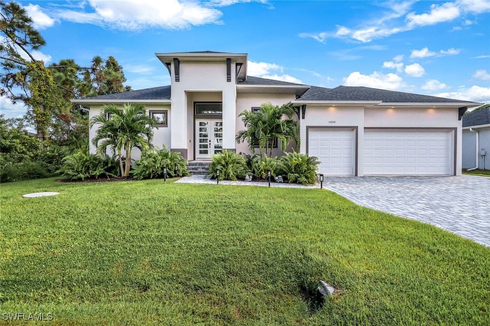 Prairie-style home with a front yard, a garage, an