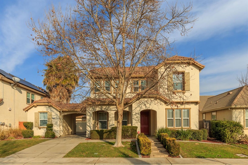 Stucco exterior and tile roof, with the one car ga
