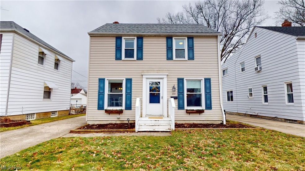 Colonial home with a front yard