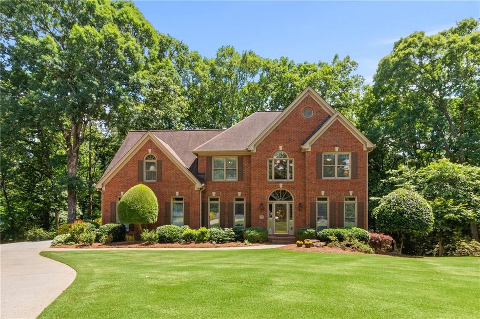 Colonial inspired home featuring a front lawn