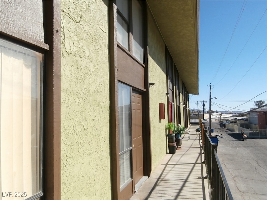 View of side of home with a balcony and stucco sid