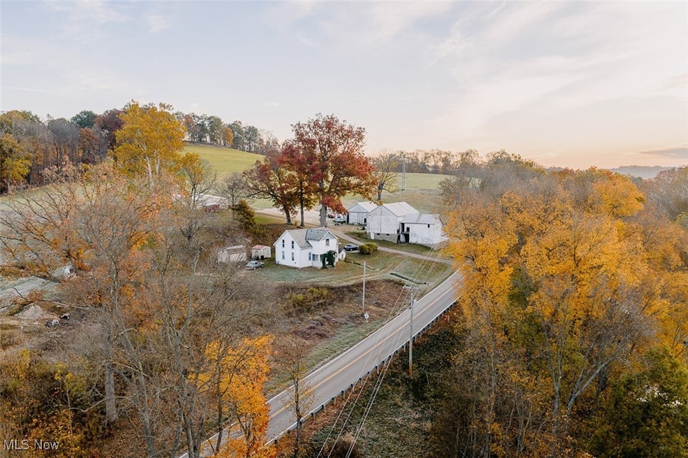 View from above of property featuring a tree filled landscape