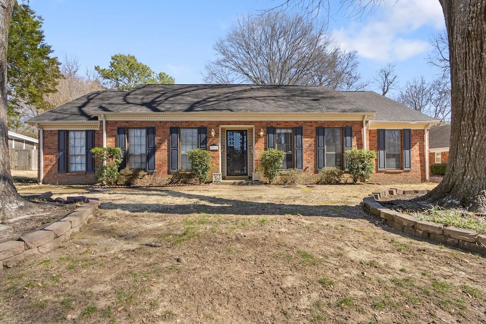 Ranch-style home with brick siding and roof with s