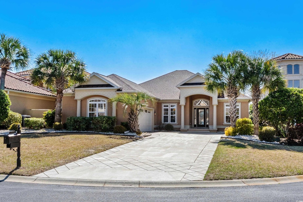 View of front of house featuring an attached garage, concrete driveway, a front lawn, and stucco siding