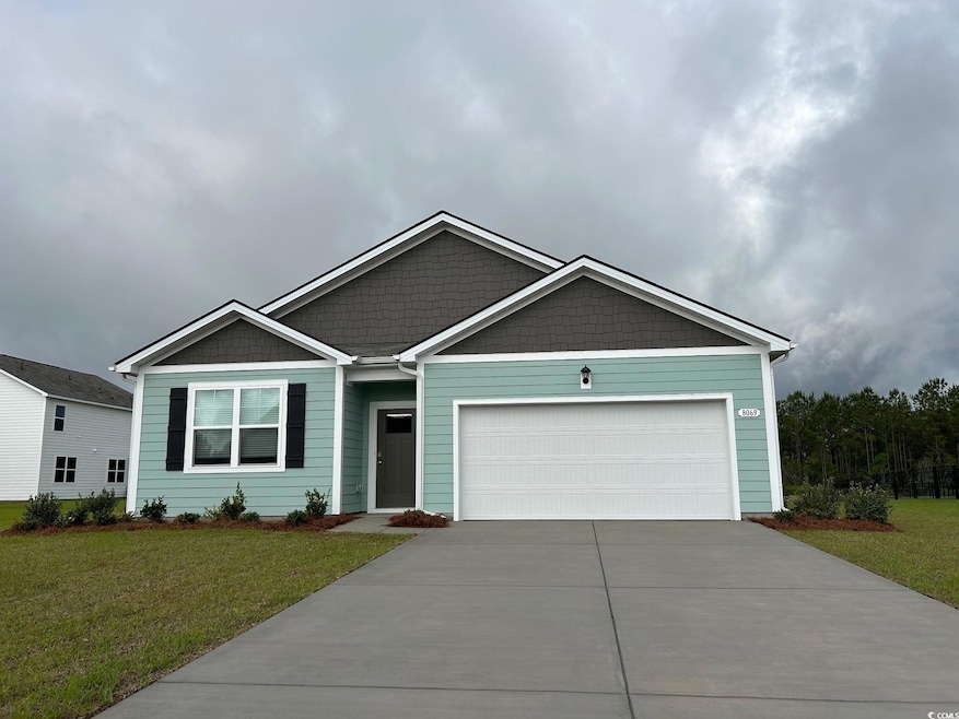 View of front of home with driveway, a garage, and a front lawn