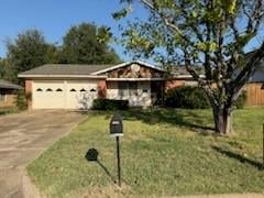 Single story home featuring a front lawn and a garage