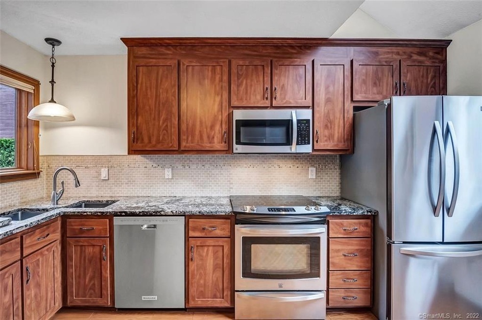 Remodeled kitchen with cherry cabinets, granite co