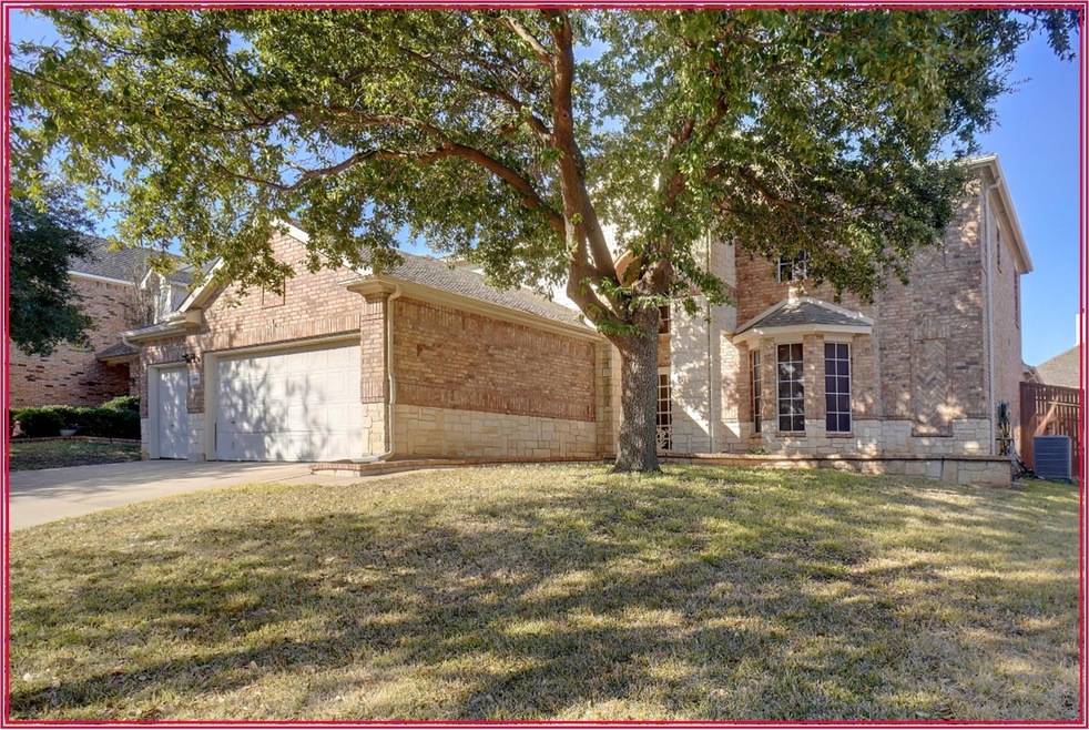View of front of home featuring a garage, cooling 