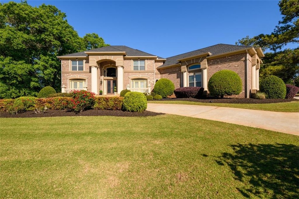 View of front of home with a front lawn, brick sid