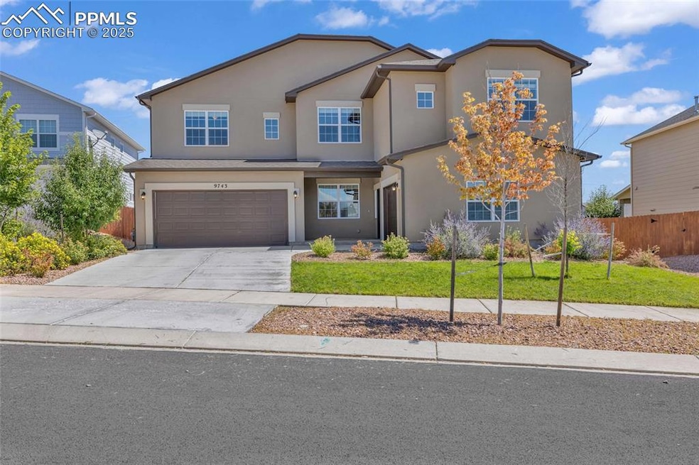 Traditional-style home with driveway, a garage, and stucco siding