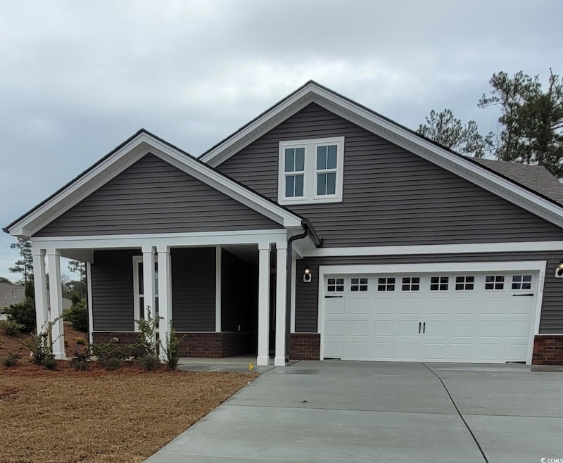 Craftsman-style house with a garage and a porch