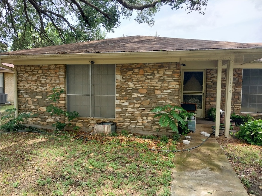 Entrance to property with stone siding, roof with