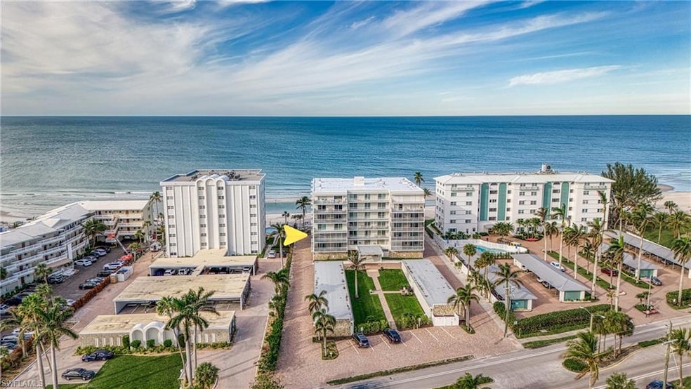 Drone / aerial view of apartment complex and a nearby body of water