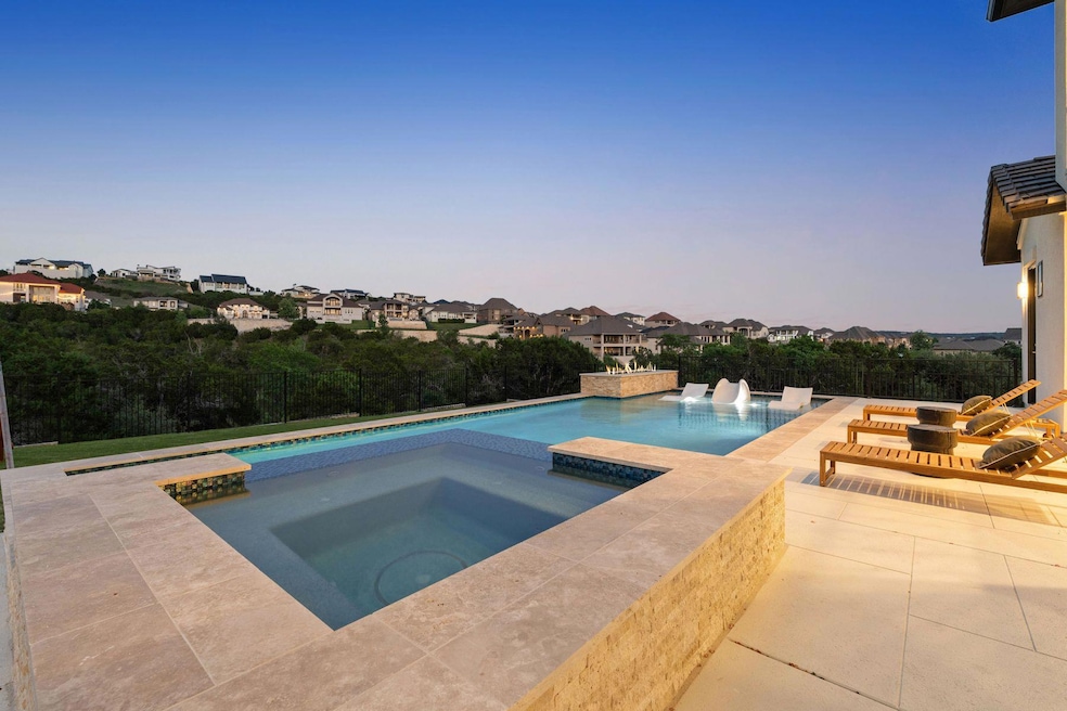 View of pool featuring an in ground hot tub, a fe