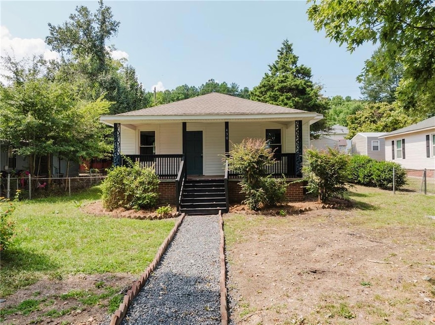 Bungalow-style home with a porch and a front lawn