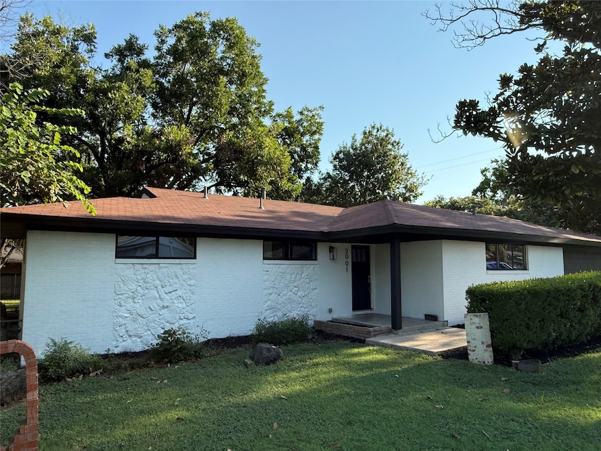 View of front facade featuring a front yard and brick siding