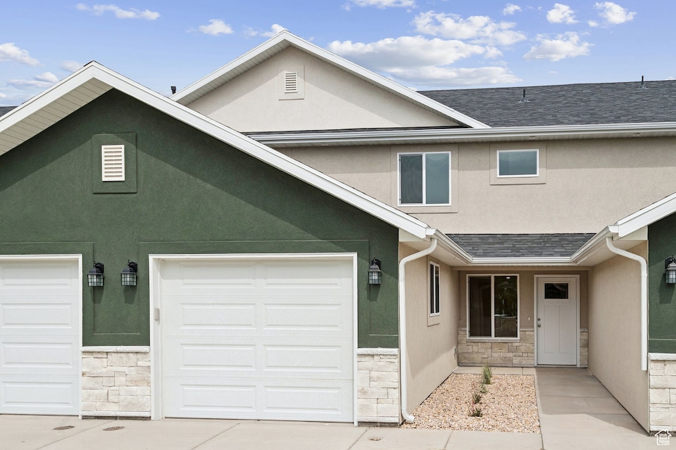 Traditional-style home featuring stucco siding and stone siding