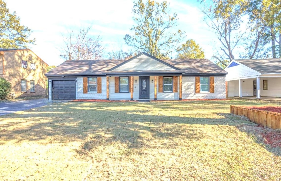 Ranch-style home with covered porch, a garage, and