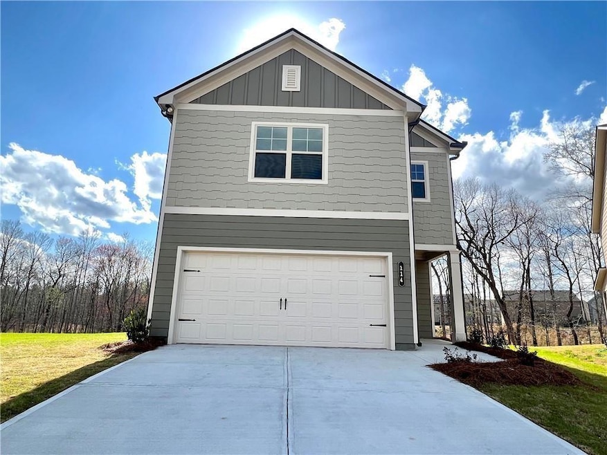 View of front of home featuring driveway, a garage, and board and batten siding