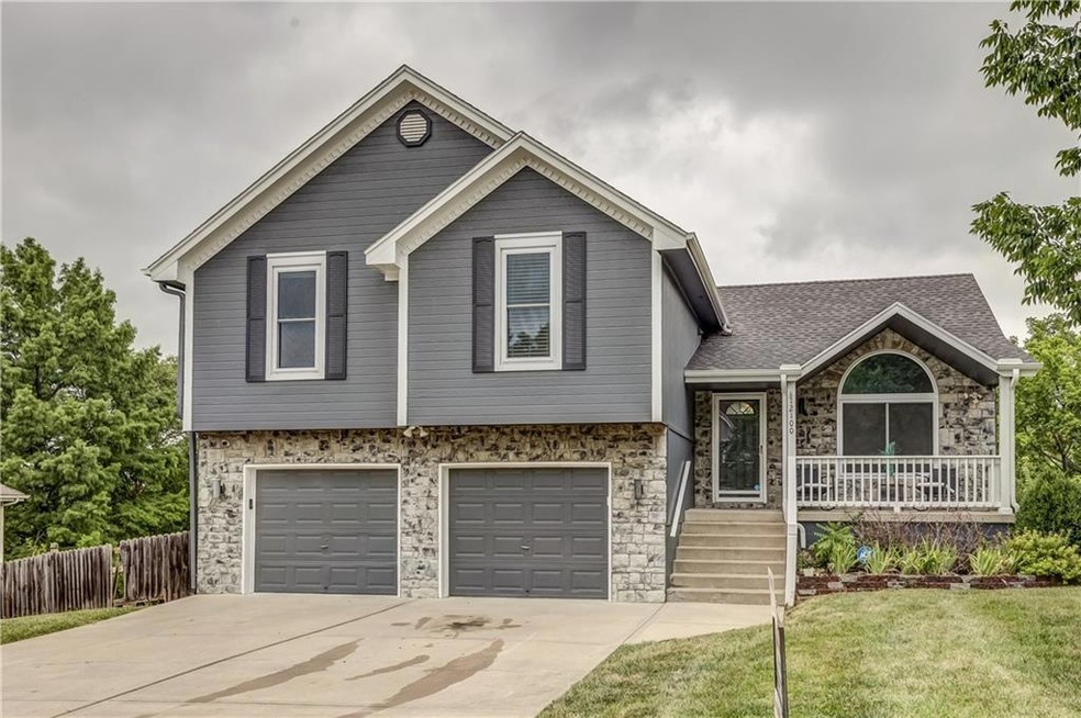 Tri-level home with a front lawn and a 2 car garage