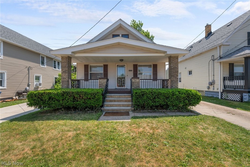 View of front of property featuring covered porch and a front yard