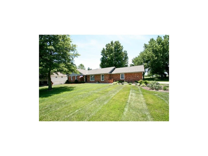 Large manicured yard, side entry garages adjacent 