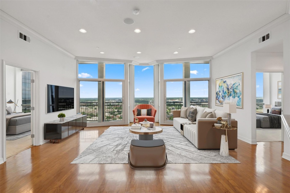 Living room with crown molding, light wood-type fl