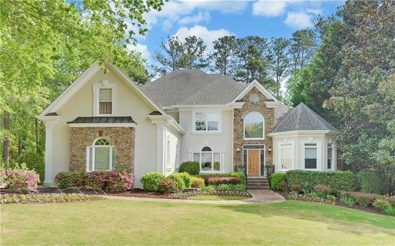 Beautiful Curb Appeal with stacked stone and archi