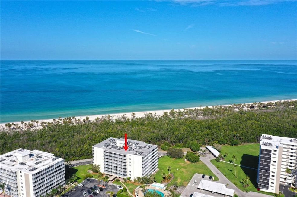 Bird's eye view featuring a water view and a beach