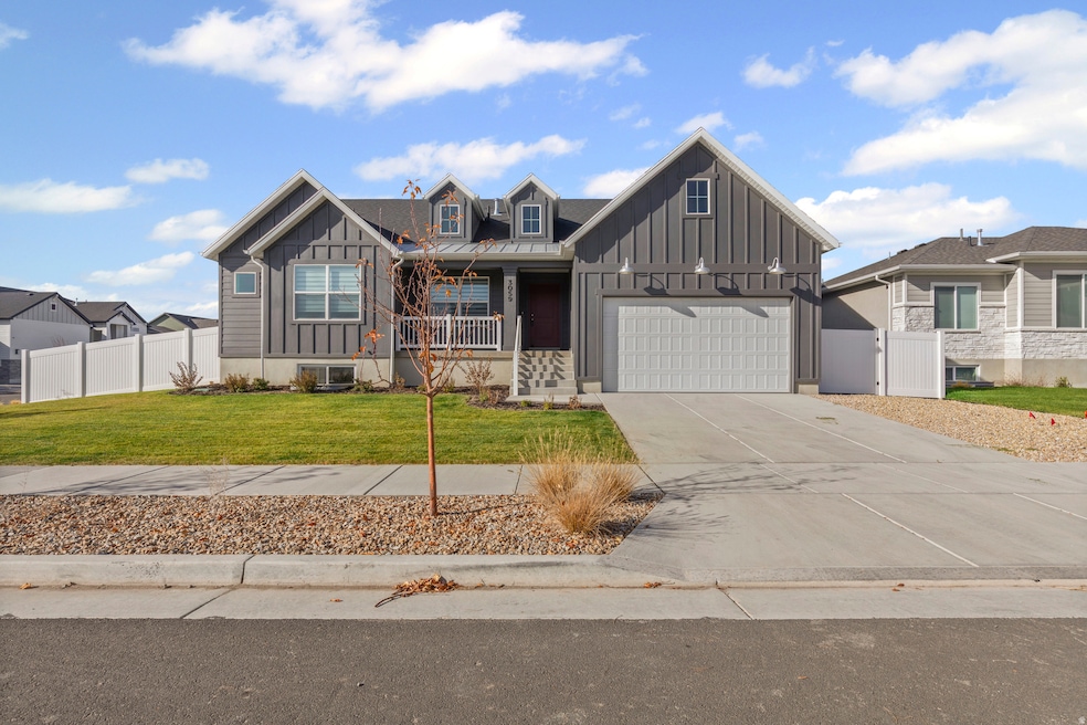 View of front of property with board and batten siding, a porch, driveway, and a garage