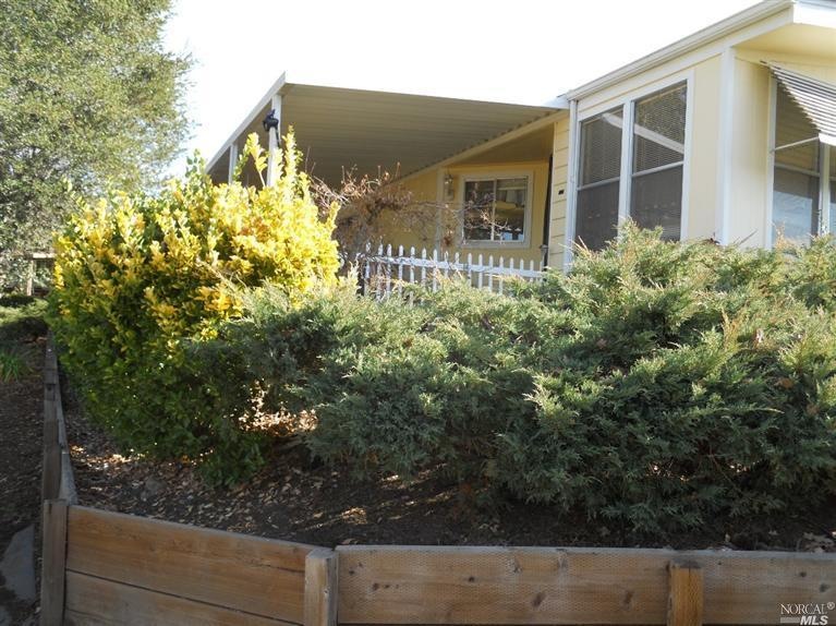 Front of home from walking path in front of creek.