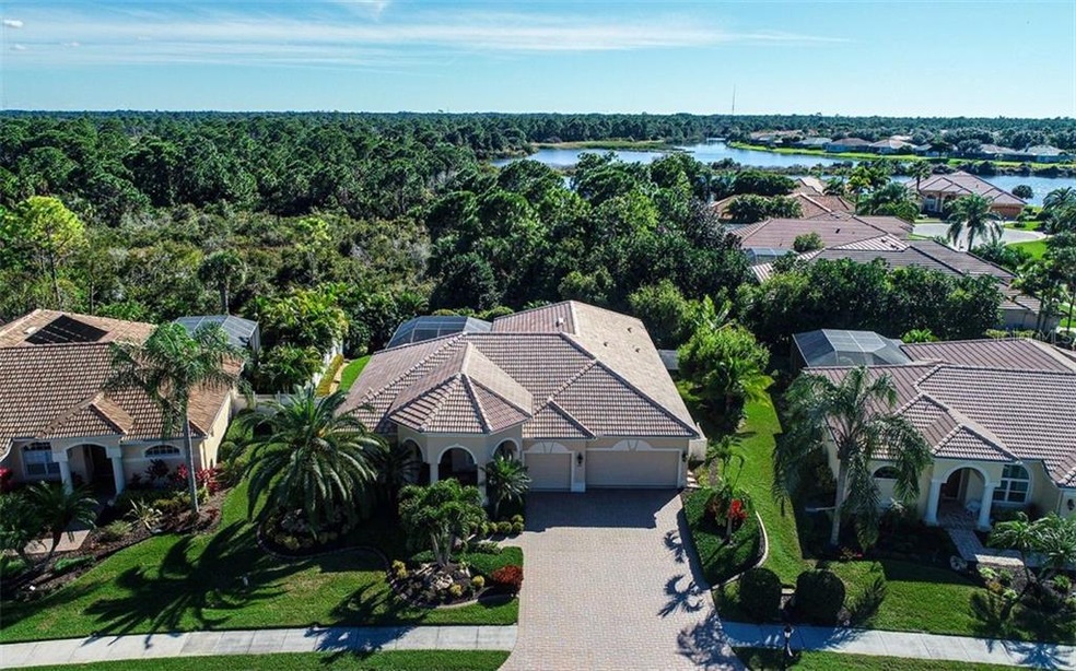 front view with 3 car garage, paver brick driveway