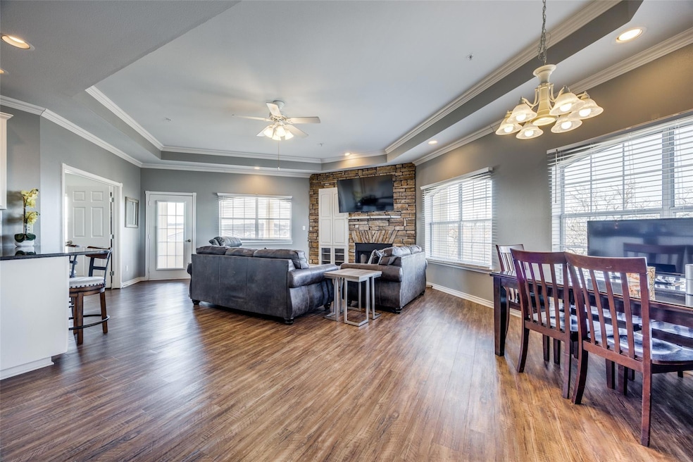 Living room featuring a raised ceiling, dark hardw