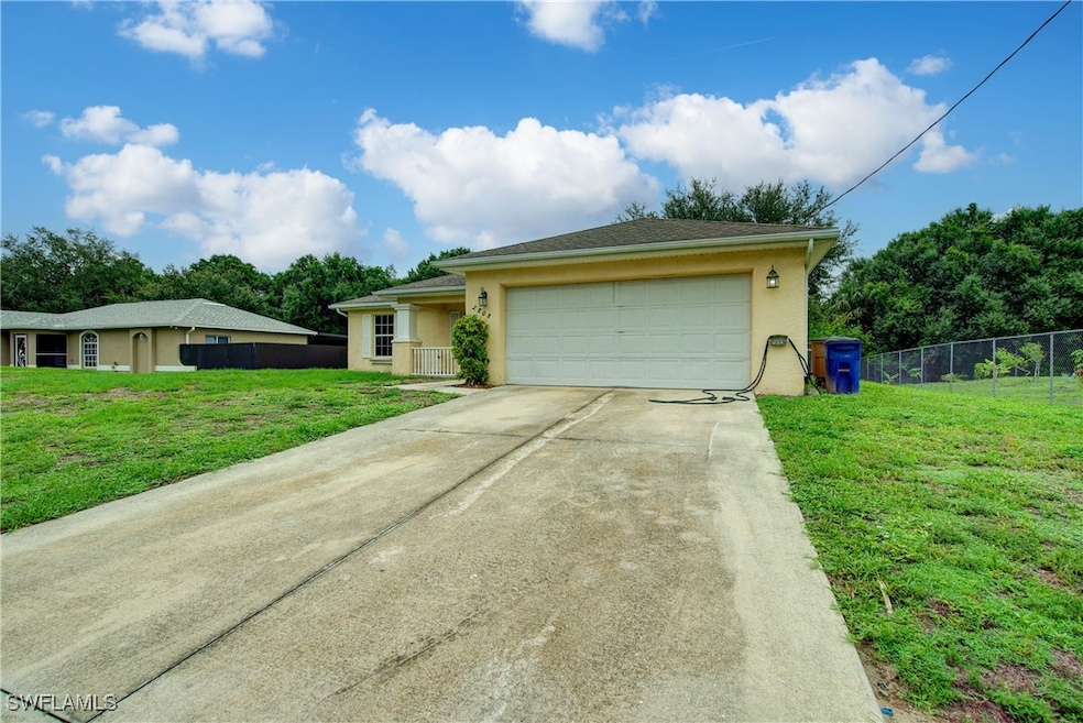 Ranch-style home with stucco siding, driveway, and