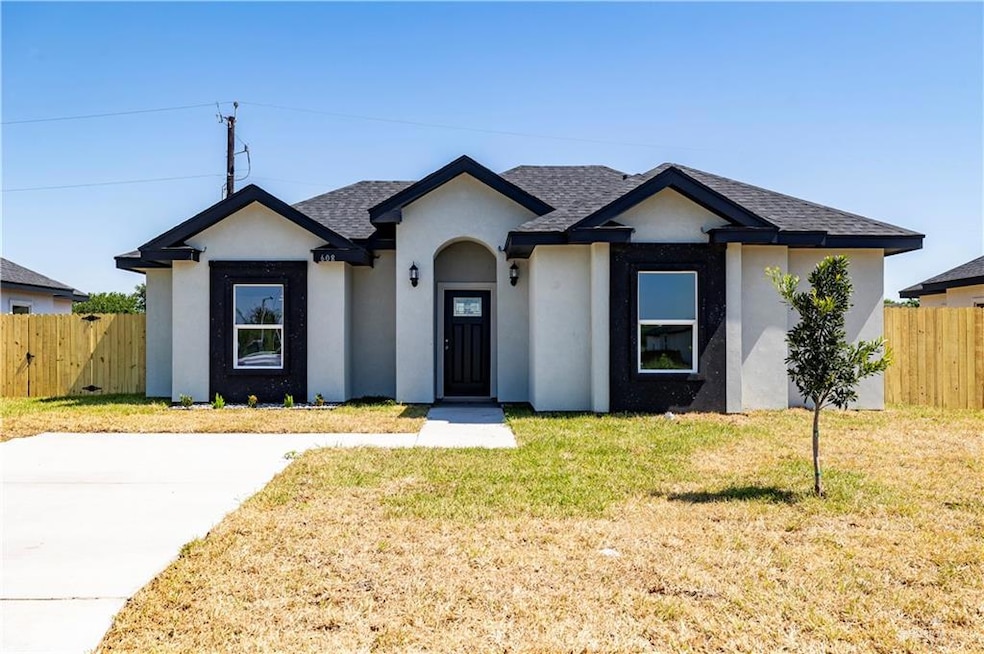 View of front of property with stucco siding and roof with shingles