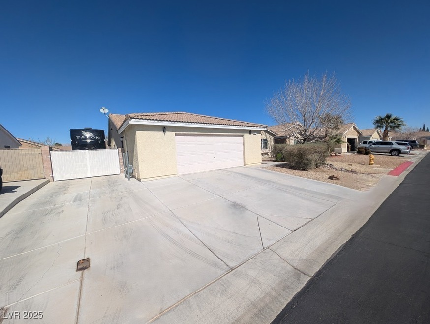 View of side of home featuring a tile roof, stucco