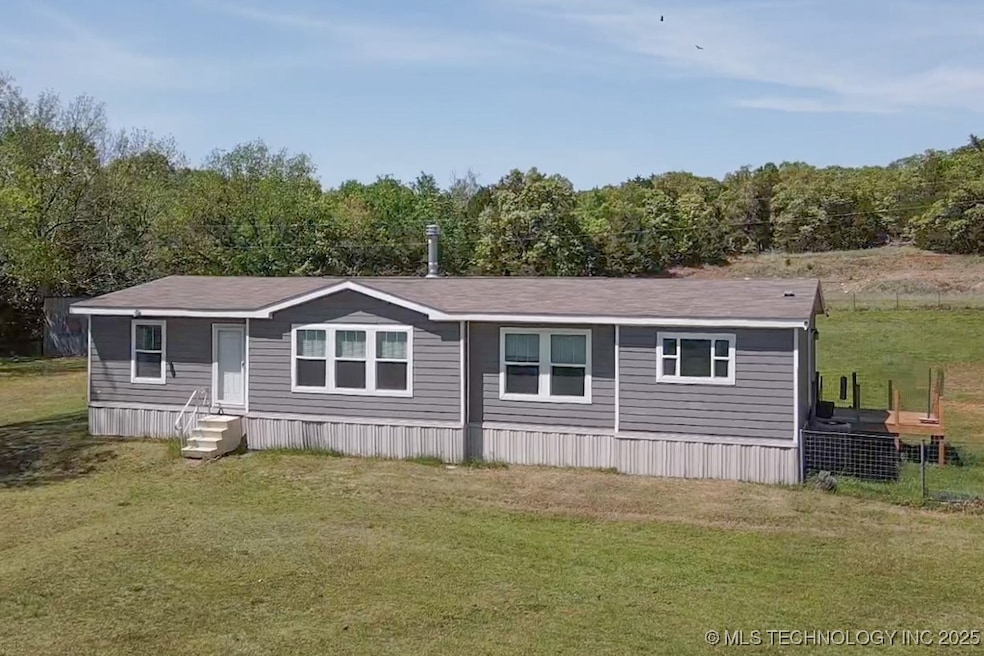 View of front of house with a front yard and entry