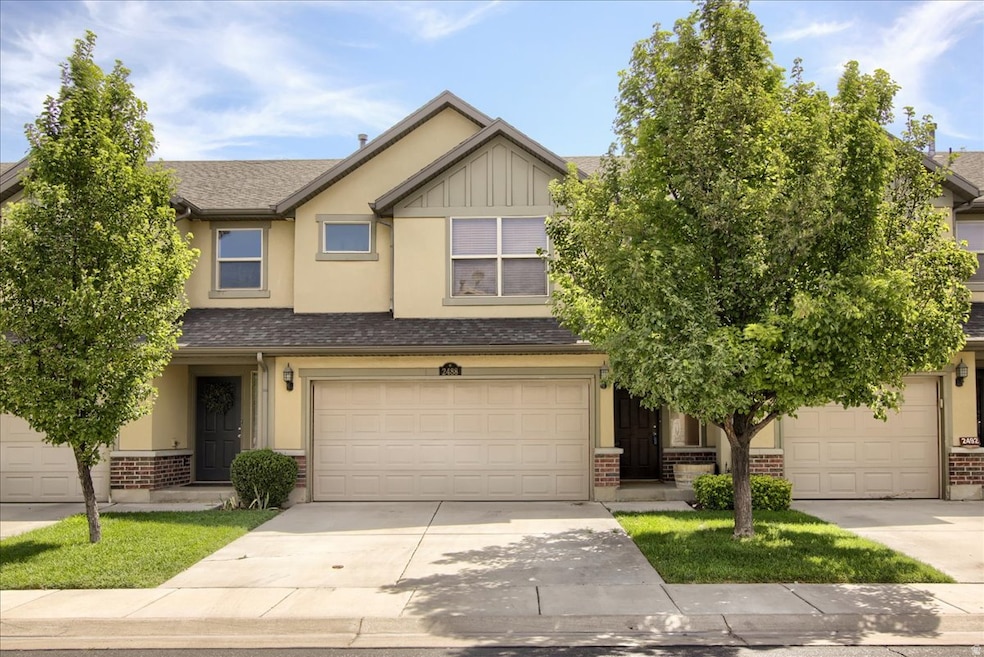 Craftsman-style house with roof with shingles, brick siding, and concrete driveway