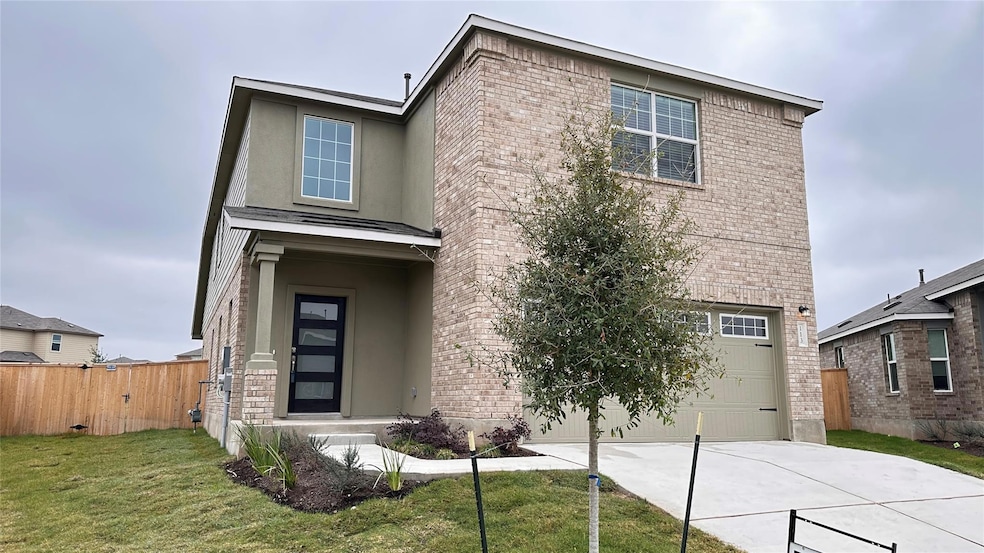 Traditional-style home featuring concrete drivewa
