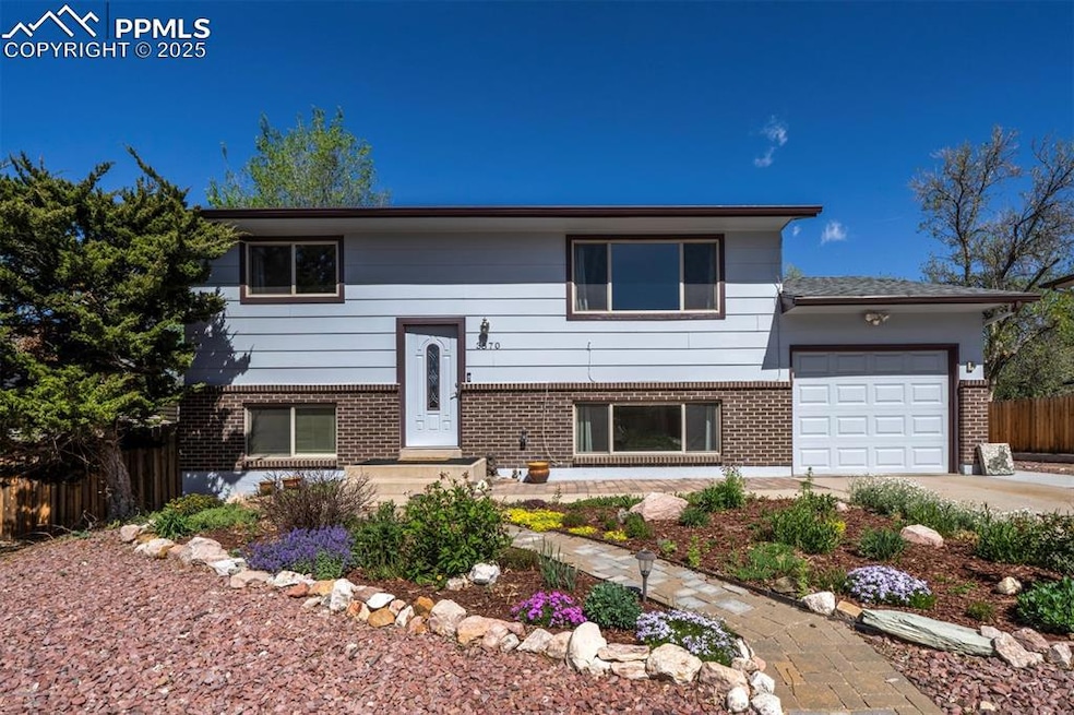 View of front of house with brick siding, a garage