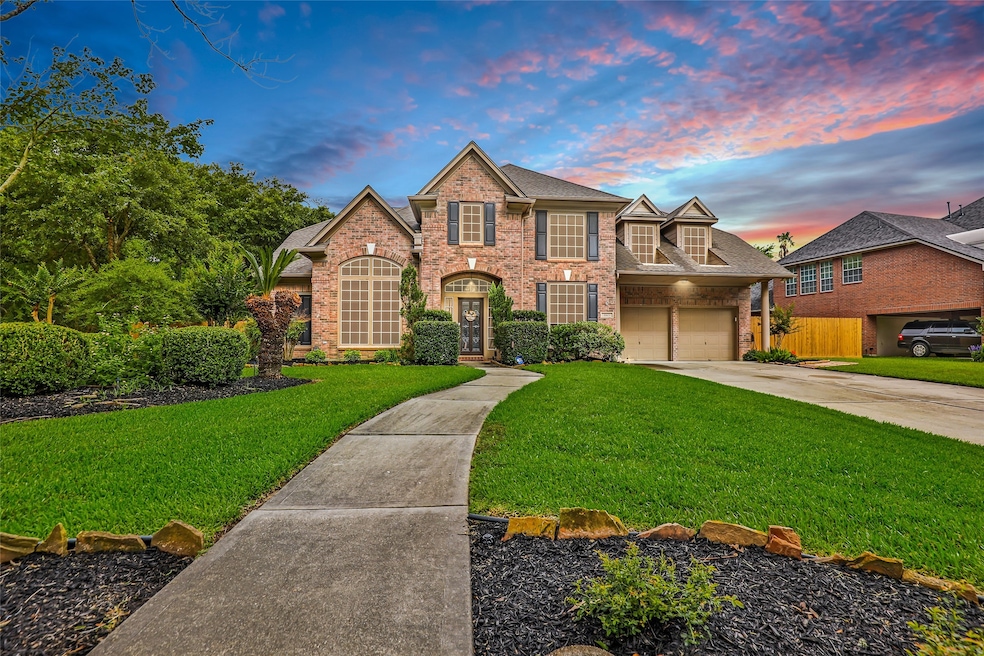 Stately front view of a two-story brick home with