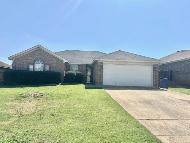 Home with a front garage and a front yard
