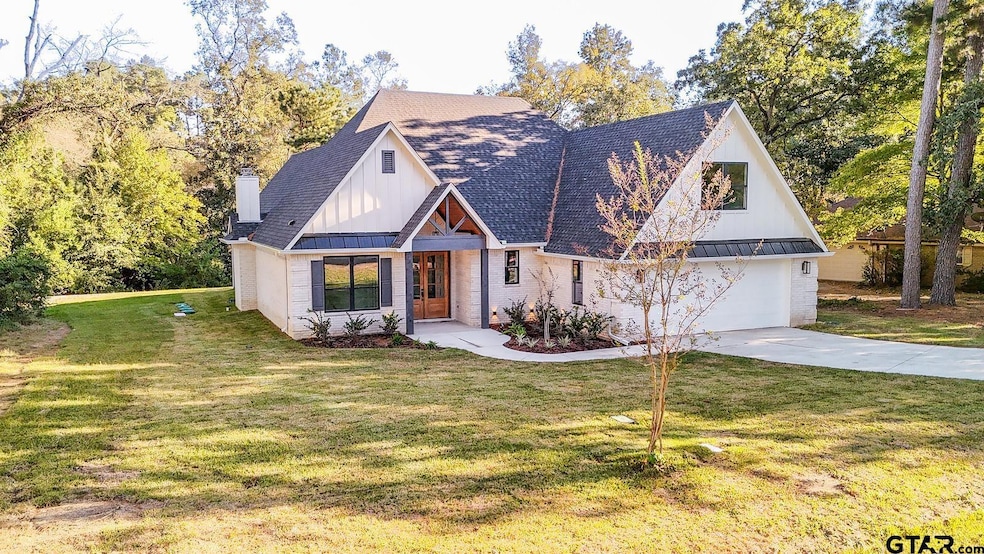 On a quiet Hideaway Lake cul-de-sac, this new-construction beauty blends modern & luxury