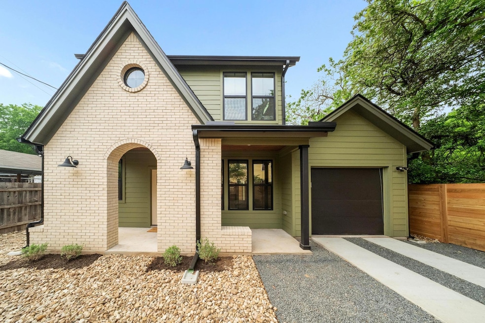 View of front facade with aphalt driveway, fence,