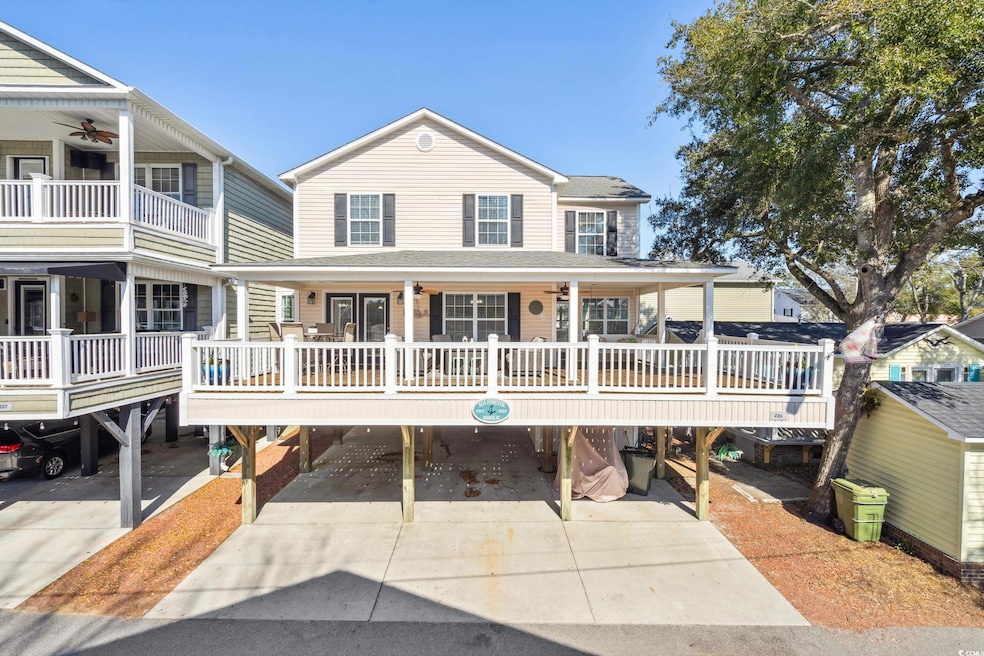 Coastal inspired home with a carport, covered porc