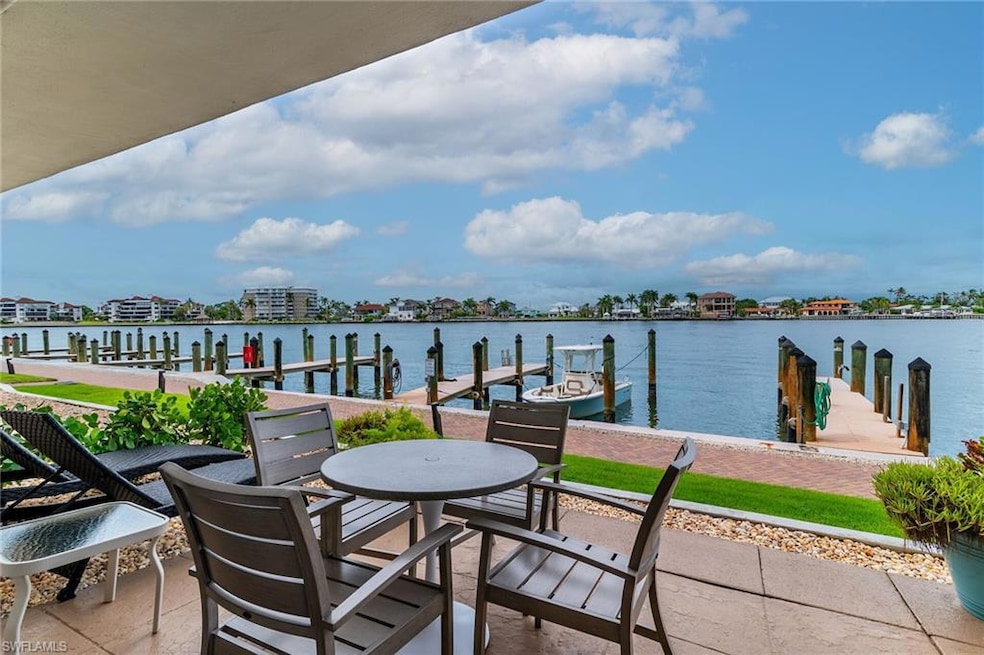 Patio featuring a dock and a water view