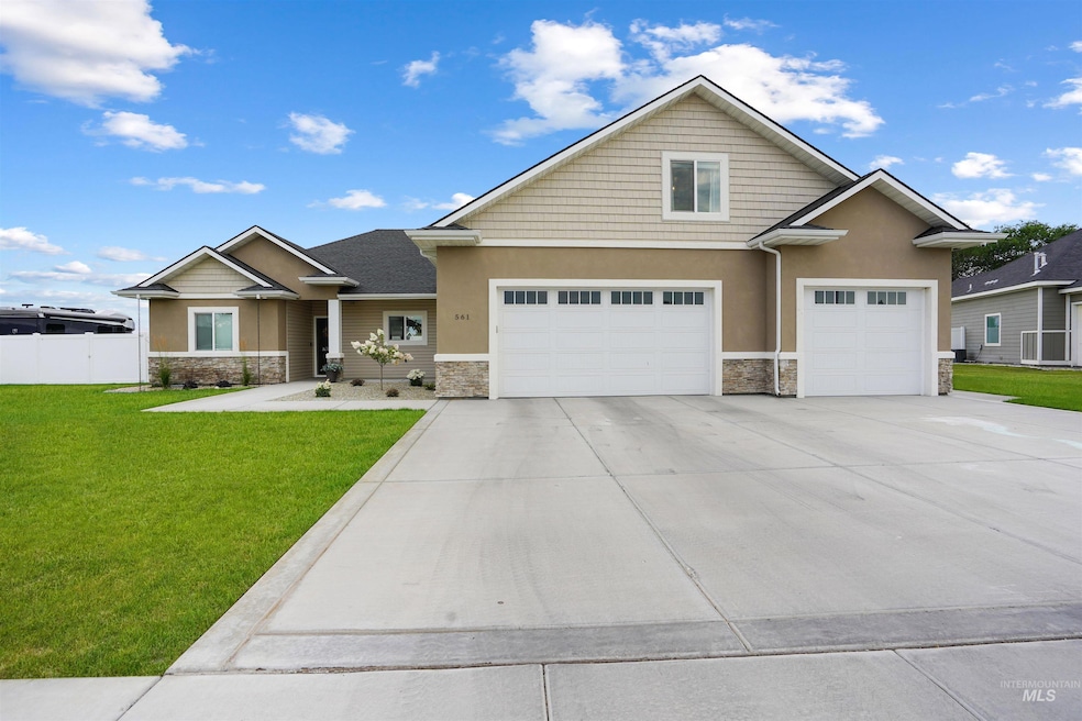 Craftsman-style house featuring stone siding, concrete driveway, stucco siding, and a garage