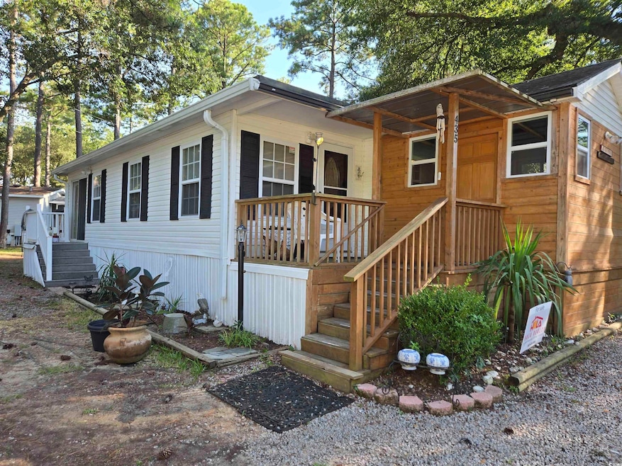 View of front facade featuring covered porch and stairs