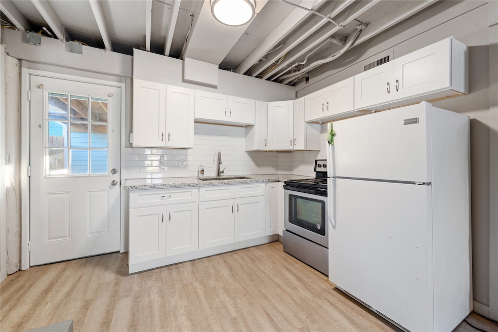 Ample white cabinetry and gleaming granite counter