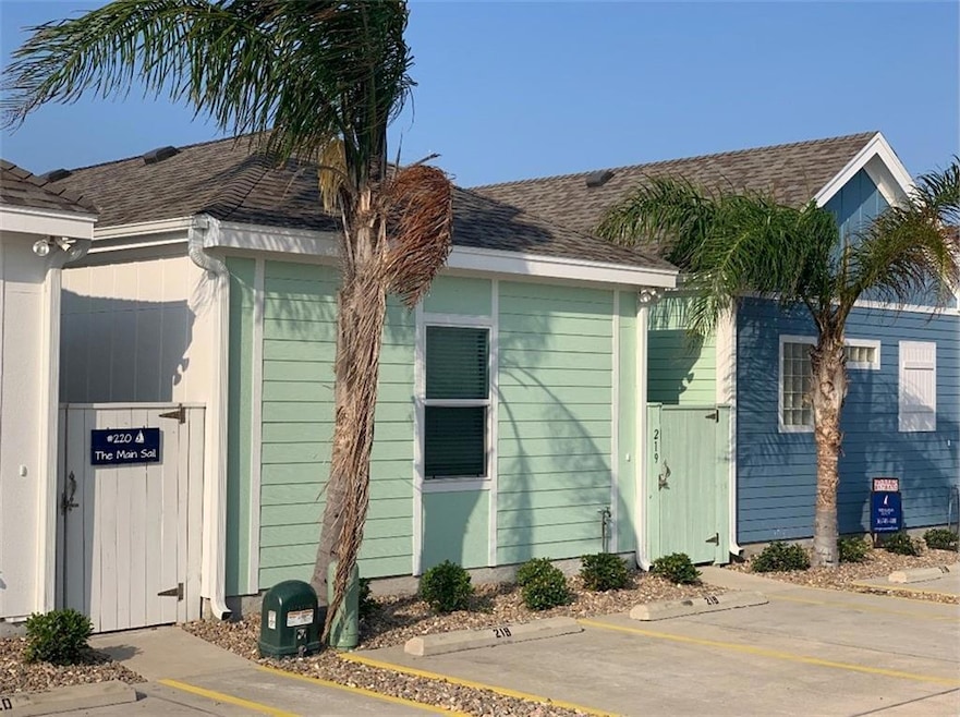 View of property exterior with uncovered parking 
